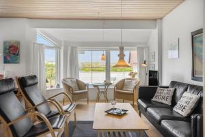 a living room with a couch and chairs and a table at 323-Harboore-Skalvej-4-a in Harboør
