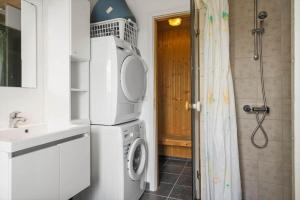 a bathroom with a washing machine and a sink at 323-Harboore-Skalvej-4-a in Harboør +23 photos