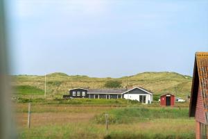 a group of houses with hills in the background at 323-Harboore-Skalvej-4-a in Harboør