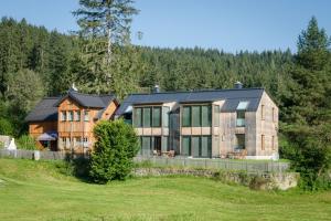 a large house in the middle of a field at Sportappartements in Bad Mitterndorf