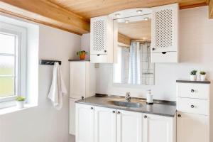 a bathroom with a sink and a mirror at 0002-Romo-Juvrevej-89 in Høm +19 photos