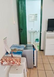 a room with a table and a sink and a bathroom at Parada da Cal Beach Torres in Torres