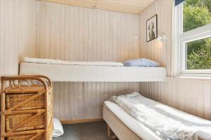 a room with two bunk beds and a window at 0021-Romo-Ringvejen-74 in Høm