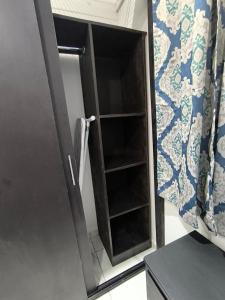 a cabinet in a kitchen next to a refrigerator at Descanso y Comodidad en Reynosa in Reynosa