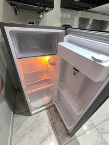 an empty refrigerator with its door open in a kitchen at Descanso y Comodidad en Reynosa in Reynosa