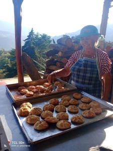 una donna in piedi davanti a un vassoio di ciambelle di Ecuturisticos Barbacoa casa de la luna a Cáqueza