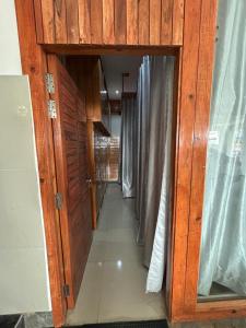 a corridor of a room with wooden walls and curtains at Dadhwal Zostel in Dharmsāla