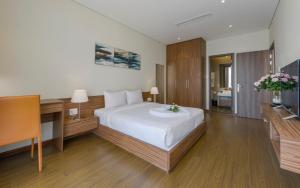 a hotel room with a bed and a television at Aurora Serviced Apartments in Ho Chi Minh City +51 photos