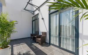 an office area with glass doors and plants at Aurora Serviced Apartments in Ho Chi Minh City