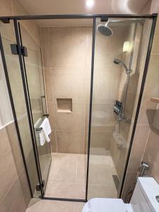 a shower with a glass door in a bathroom at TWIN PALMS 'Beach House' - New surf front location in Thulusdhoo +28 photos