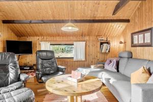 a living room with a couch and chairs and a table at 0009-Romo-Thadesvej-37 in Høm