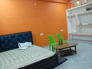 a bedroom with a bed and a table and chairs at Om Mansion in Varanasi