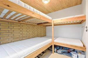 two bunk beds in a room with a brick wall at 11804-Nykobing-Sj-Linesvej-2 in Nyrup