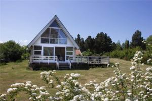 a house on top of a hill with white flowers at 11804-Nykobing-Sj-Linesvej-2 in Nyrup