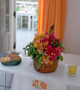 a vase filled with flowers on top of a table at Nicolas Antiparos in Antiparos