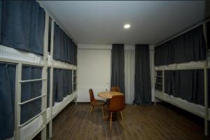 une chambre avec deux lits superposés et une table et des chaises dans l'établissement Gоderdzi Twins Hotel, à Goderdzi