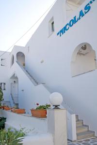 a large white building with a sign on the side of it at Nicolas Antiparos in Antiparos