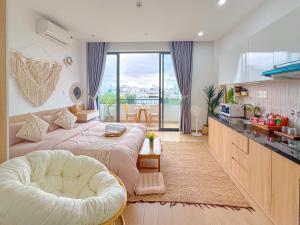 a bedroom with a large bed and a kitchen at BaBô Homestay Da Nang in Danang