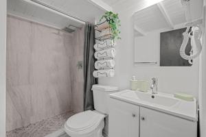 a white bathroom with a toilet and a sink at Old San Juan - Loft Balcony in San Juan +19 photos