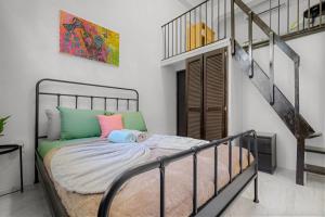 a bedroom with a bed and a staircase at Old San Juan - Loft Balcony in San Juan