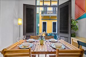 a dining room with a wooden table and chairs at Old San Juan - Loft Balcony in San Juan