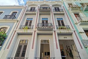 an apartment building with balconies on a city street at Old San Juan - Loft Balcony in San Juan