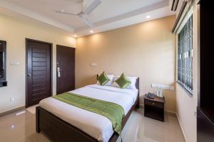 Rúm í herbergi á Treebo Adin Residence Chennai Trade Centre