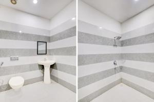 卢迪亚纳Super Hotel O Neopolis Mall Ludhiana Formerly Silver Sky的带有条纹墙壁、马桶和水槽的浴室