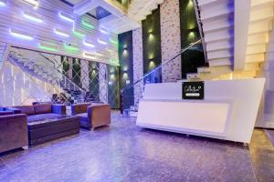 a lobby with a waiting area with couches and a table at Collection O Rudrapur Bus Stand Formerly Corinthian in Rāmpura