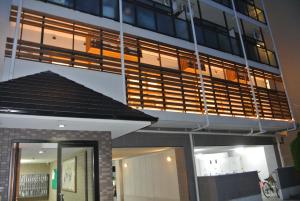 a tall building with a lit up facade at Backpackers Hotel NOOSA JAPAN in Takatsuki Tonda in Takatuki