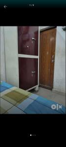 a bedroom with a bed and a wooden cabinet at josh poonam in Prayagraj