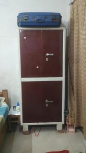 a dresser with a suitcase on top of it at josh poonam in Prayagraj