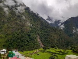 a view of a mountain with a green valley at Hotel Arpit in Sonprayag