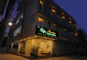 een gebouw met een uithangbord aan de zijkant bij Munderi Green Mounts - Premium Pool Stay Near Kalpetta, Wayanad in Kalpatta