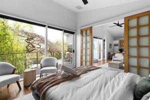 a bedroom with a large bed and a balcony at 2BR plus Studio Pool & Spa Sleeps 8 in Daylesford +21 photos
