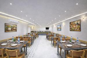 a dining room with wooden tables and chairs at Hotel Apple Wood Delhi Airport With Free Airport Drop in New Delhi