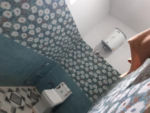 a bathroom with a shower curtain and a toilet at Hotel Arpit in Sonprayag