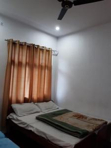 a bed in a room with a curtain at Hotel Arpit in Sonprayag +13 photos