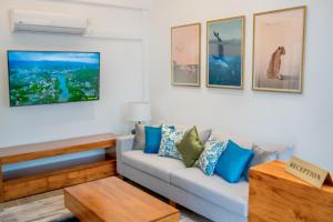 a living room with a couch and paintings on the wall at Alankara Retreats Colombo 07 in Colombo