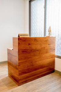 a wooden desk in a room with a window at Alankara Retreats Colombo 07 in Colombo