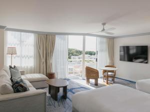 a hotel room with a couch and a living room at Elysium Noosa Resort - MGallery Collection in Noosa Heads +50 photos