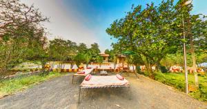 a picnic table in the middle of a dirt road at Tejas Gir Villas in Sasan Gir