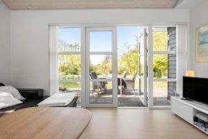 a living room with a table and a sliding glass door at LF21632-Spottrup-Rylevej-1 in Spottrup