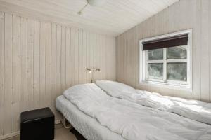 a large white bed in a room with a window at LF21632-Spottrup-Rylevej-1 in Spottrup