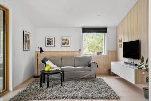 een woonkamer met een bank en een tafel bij LF10320-Hurup-Thy-Nattergalevej-2-B in Sønder Ydby