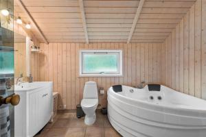 a bathroom with a tub and a toilet and a sink at LF21631-Spottrup-Vibevej-3 in Spottrup +17 photos
