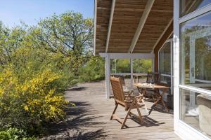 a porch of a house with a table and chairs at LF21631-Spottrup-Vibevej-3 in Spottrup