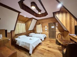 En eller flere senge i et værelse på Magmai HomestayTak