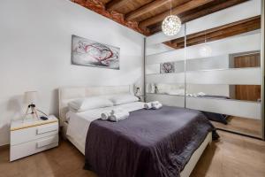 a bedroom with a large bed with towels on it at Damiani Appartamenti nel Centro Storico di Palermo in Palermo +46 photos