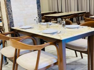 a table with plates and glasses on it in a restaurant at Desert Rose Hotel in Siwa